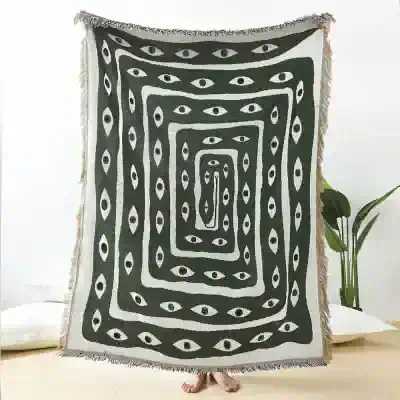 Bright monochrome throw blanket with eye motif, perfect for modern bedroom decor and adding a stylish touch to your living space.