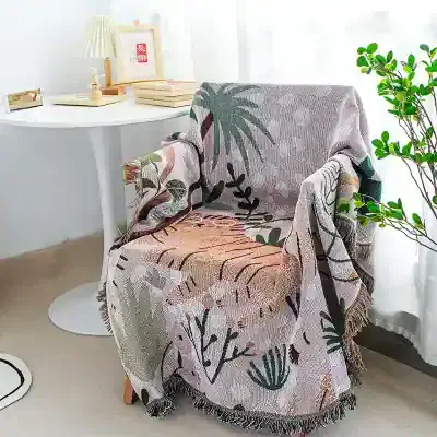 Soft woven throw blanket with botanical print, perfect for home decor and cozy living spaces.