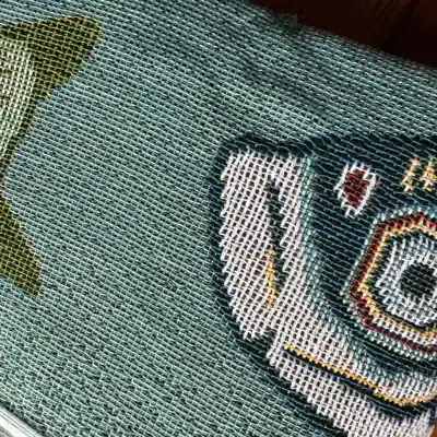 High-quality embroidered patch on woven fabric background showcasing Monalisa Medical branding. Perfect for medical uniforms, accessories, or promotional items, combining durability with vibrant design.