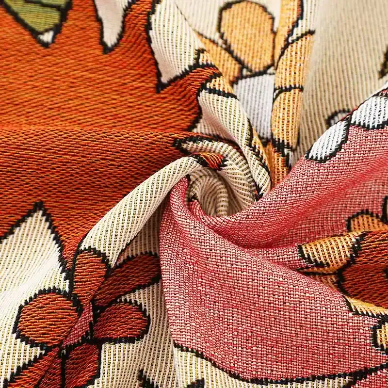 Vibrant floral patterned fabric with intricate woven texture, ideal for fashion, home decor, and craft projects. Bright colors and detailed design enhance visual appeal for textile enthusiasts.