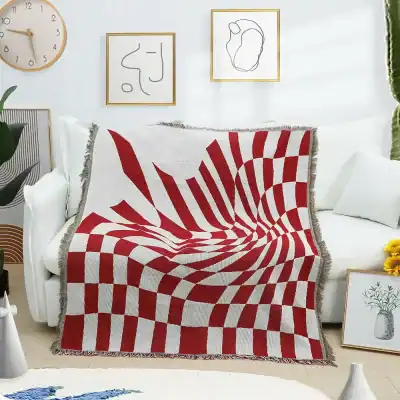 Red and white optical illusion throw blanket on white sofa, modern home decor, stylish textile for living room, Monalisa Store opt home accessories, contemporary design, geometric pattern, cozy and fashionable throw.