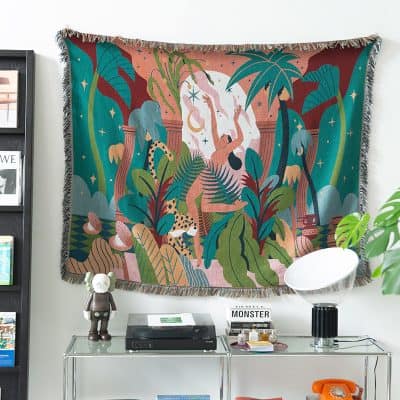 Vibrant jungle-themed tapestry with human figures, animals, and lush foliage, perfect for modern interior decor and adding a colorful artistic touch to living spaces.