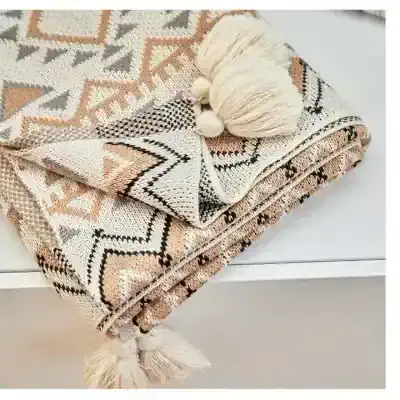 Soft woven throw blanket with geometric patterns and tassel accents, perfect for cozy home decor and stylish comfort.