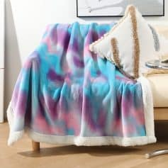 Vibrant pastel tie-dye fleece blanket on a cozy sofa at Monalisa Store, ideal for home comfort and stylish decor.