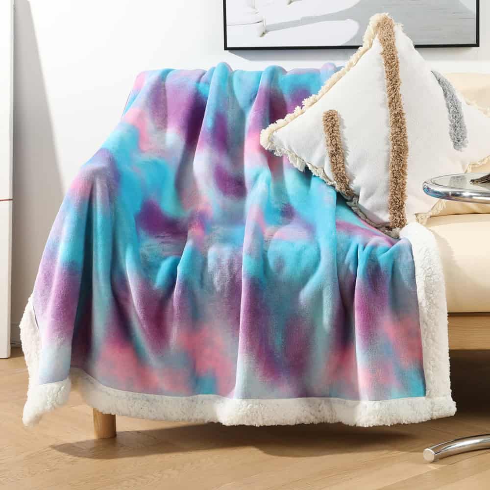 Vibrant pastel tie-dye fleece blanket on a cozy sofa at Monalisa Store, ideal for home comfort and stylish decor.