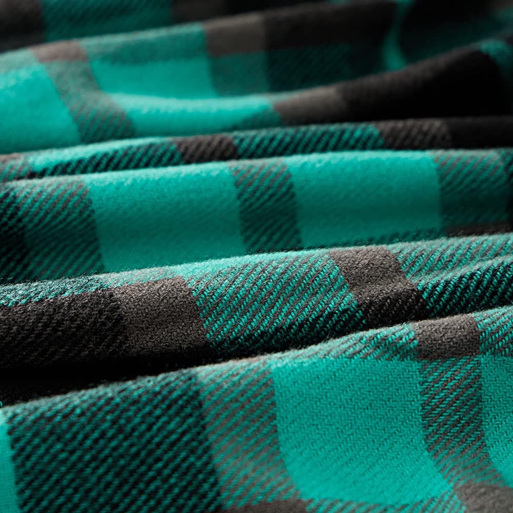 Soft teal and black checkered fabric displayed in close-up, ideal for clothing or fashion accessories. Perfect for trendy, stylish apparel with a comfortable, cozy texture. Great for fall and winter wardrobe essentials.