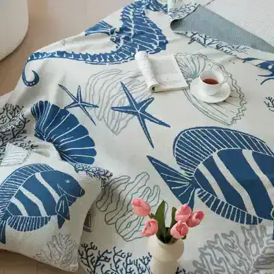Bright blue and white ocean-themed coastal bedspread featuring seashells, starfish, and coral for a relaxing bedroom decor at Monalisa Store.