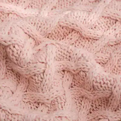 Soft pink knitted fabric with intricate cable patterns, perfect for cozy accessories or garments. Ideal for making warm scarves, sweaters, and stylish home textiles. High-quality, comfortable, and fashionable.