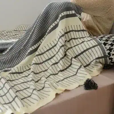 Woven black and white striped throw blanket for stylish home decor and comfort, perfect for bedroom or living room, made from soft, high-quality material, featuring geometric patterns for modern aesthetic.