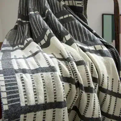 Black and white patterned fabric showcasing geometric design, textile, textile texture, Monalisa Store, home décor, fabric design, modern woven textile, decorative fabric for interior use.