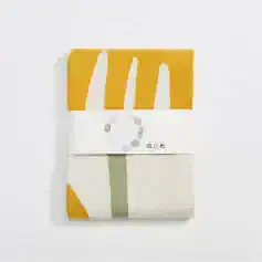 Vegan print fabric swatch with eco-friendly design and mustard, white, and green colors on monalisamedical.com.