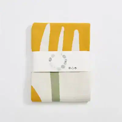 Vegan print fabric swatch with eco-friendly design and mustard, white, and green colors on monalisamedical.com.