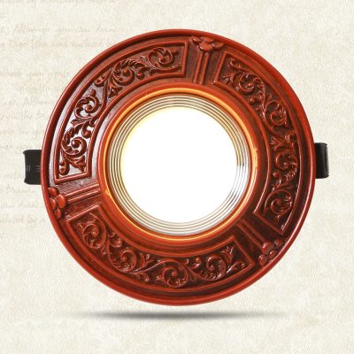 Intricate red wooden mirror frame with ornate carvings, perfect for vintage or antique-inspired interior decor.