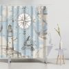 Seaside nautical-themed shower curtain featuring a lighthouse, starfish, compass, and anchor design for bathroom decor.