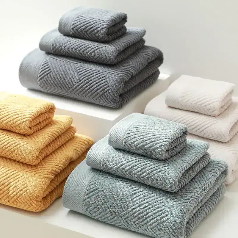 Luxurious folded towels in gray, white, and beige on display at Monalisa Store, perfect for home spa or bathroom decor, made from soft, high-quality materials.