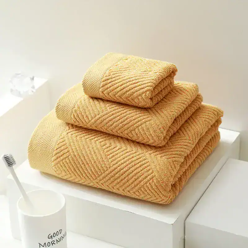 Luxurious beige towels folded on a white shelf, perfect for spa or bathroom essentials, creating a cozy and inviting atmosphere.