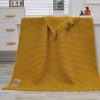 Soft yellow textured waffle knit throw blanket displayed over a white bathroom vanity, suitable for home decor, gifting, or everyday comfort, emphasizing cozy, stylish, and versatile interior accents.