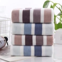 Soft, colorful striped towels stacked in a modern bathroom for stylish home decor and high-quality comfort. Perfect for skincare routines and everyday essentials.