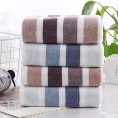 Soft, colorful striped towels stacked in a modern bathroom for stylish home decor and high-quality comfort. Perfect for skincare routines and everyday essentials.
