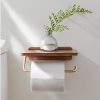 Vase with green fern on wooden wall shelf in bathroom, with toilet paper holder, minimalist bathroom decor, clean and modern aesthetic, Monalisa Medical store inspiration.