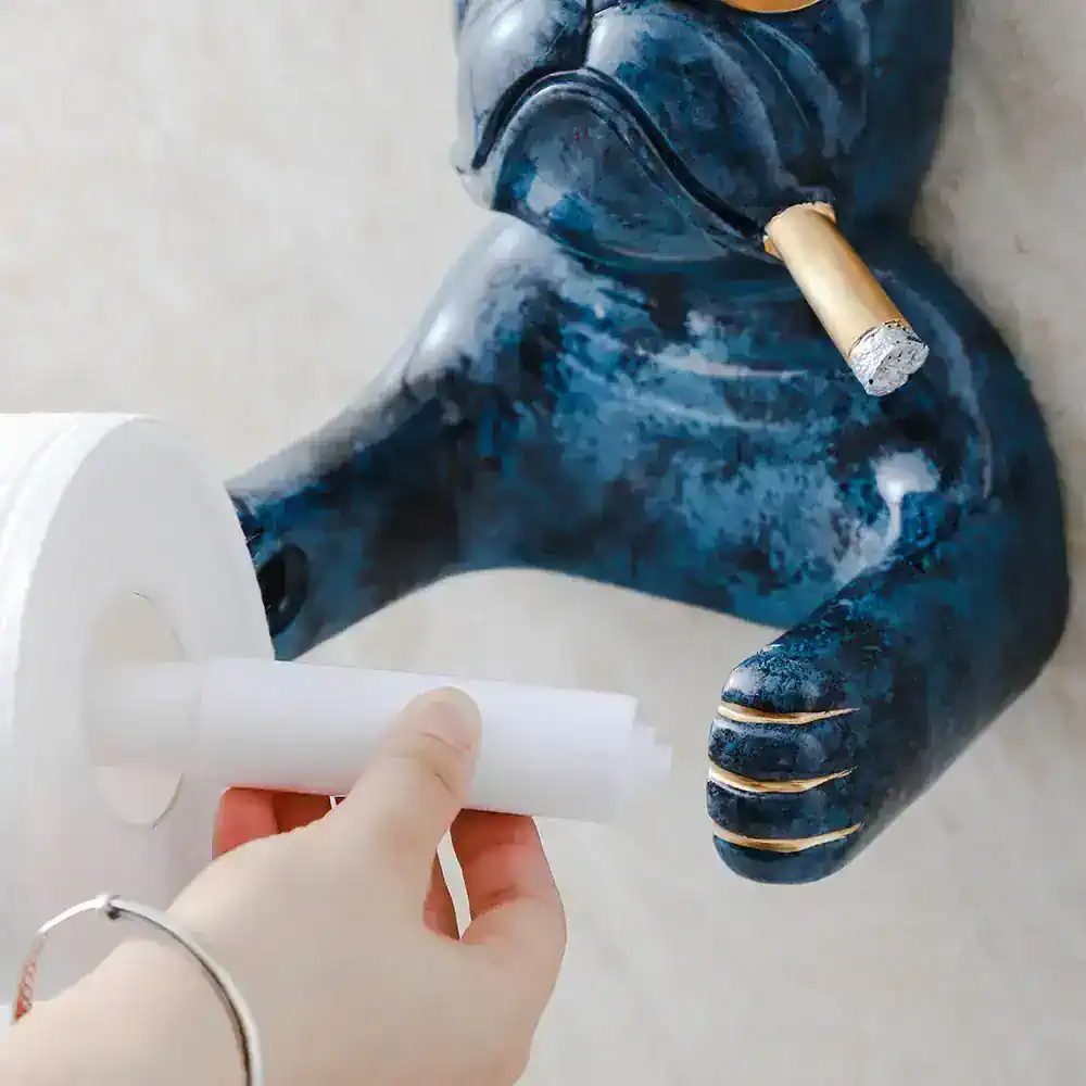 Hand holding a roll of white adhesive tape, with a blue abstract sculpture in the background, at Monalisa Store, highlighting art supplies and custom creative décor for home and office.