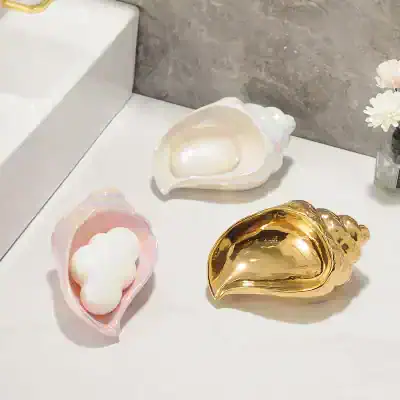 Shimmering shell-shaped containers for beauty products or jewelry with luxury gold and pearl finishes at Monalisa Store, perfect for elegant skincare or makeup storage.