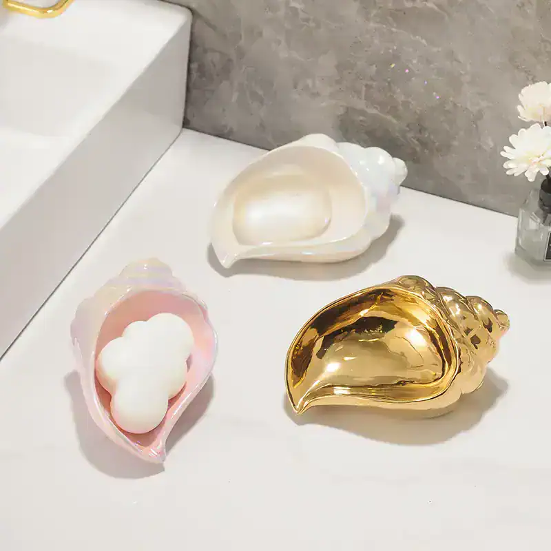Shimmering shell-shaped containers for beauty products or jewelry with luxury gold and pearl finishes at Monalisa Store, perfect for elegant skincare or makeup storage.
