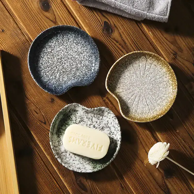 Black and gold ceramic soap dishes with textured glaze from Monalisa Store, perfect for elegant bathroom decor.