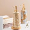 Elegant marble-look soap dispensers with gold pumps, perfect for luxury bathroom decor and skincare routines. Monalisa Store offers stylish and high-quality accessories for your home and personal care.