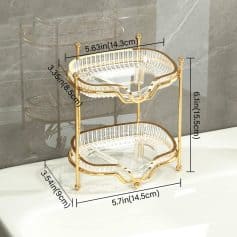 Elegant gold and glass two-tier fruit and dessert stand, perfect for home decor, parties, and serving. Stylish and functional, ideal for displaying snacks, desserts, or decorative items in a luxurious setting.