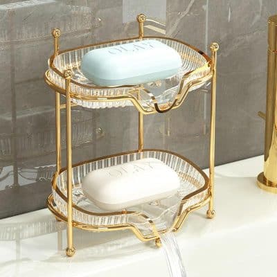 Luxurious gold and glass soap dish holder with monogrammed soap bars, designed for elegant bathrooms, featuring a two-tier design and crystal accents for a sophisticated aesthetic.