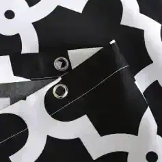 Black and white fabric with grommets, modern design, versatile textile product - perfect for fashion, accessories, or interior decor. High-quality material used for stylish and durable applications.