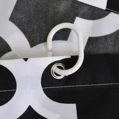 Flexible white plastic handle attached to a black and white patterned fabric tote bag, designed for secure grip and convenience, ideal for carrying medical or optical supplies.