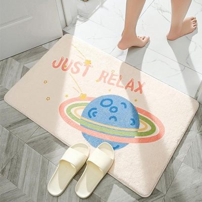 Cosmetic store entrance mat with "Just Relax" message and planet design, ideal for a welcoming ambiance in a beauty and opt store, featuring plush texture and playful space theme engaging customers.