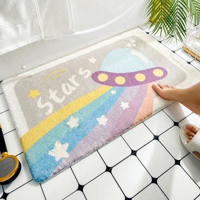 Colorful children's star-themed bath mat with spaceship design for kid-friendly bathroom decor.