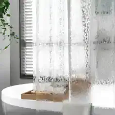 Soft white lace curtain with circular pattern, providing privacy and elegant decor for the bedroom or living space.