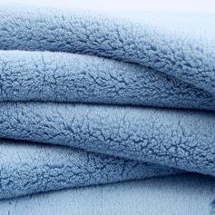 Soft blue plush fleece blanket, cozy and comfortable, perfect for home or bedroom decor, high-quality fabric, warm and inviting feel, ideal for relaxation and comfort.