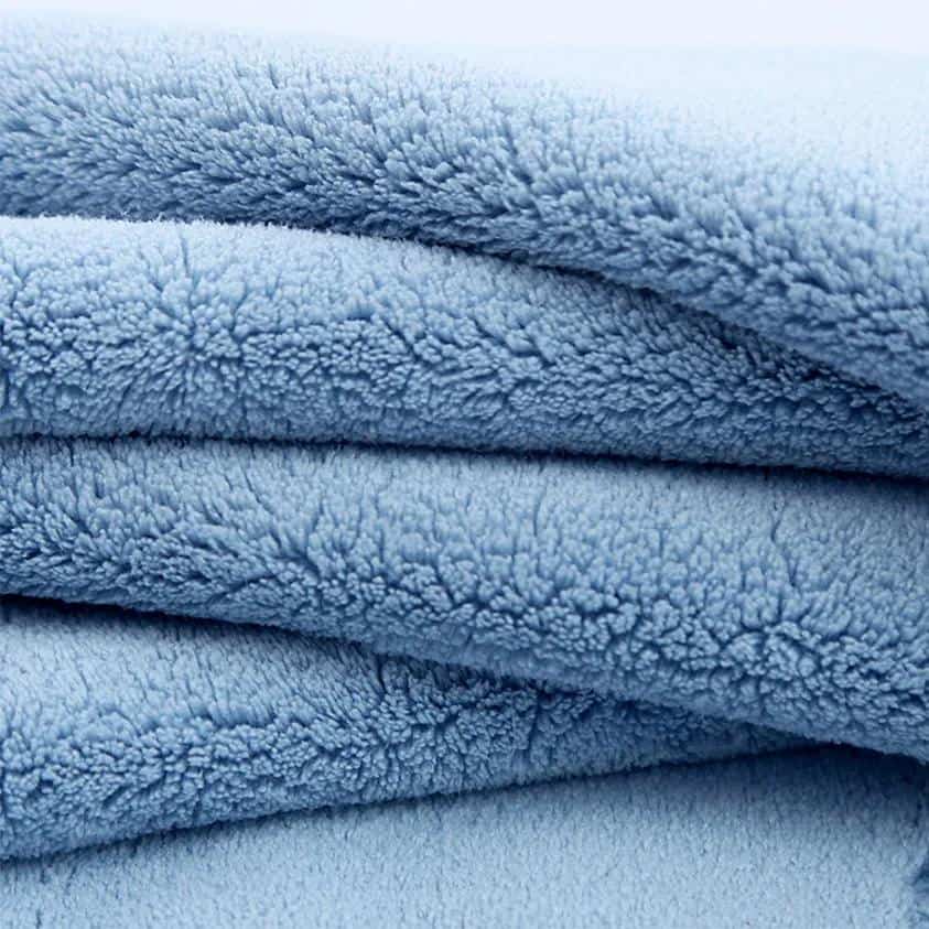 Soft blue plush fleece blanket, cozy and comfortable, perfect for home or bedroom decor, high-quality fabric, warm and inviting feel, ideal for relaxation and comfort.