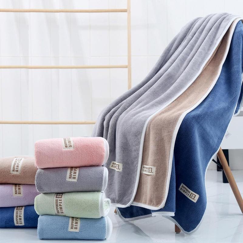 Soft plush towels in pastel colors, displayed on a clean modern bathroom setting, emphasizing luxurious and high-quality bathroom essentials. Perfect for home spa, hotel, and retail stores specializing in premium towels.