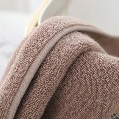Soft beige terrycloth towel with plush texture, ideal for personal care and relaxation at Monalisa Medical Store.
