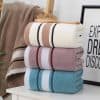 Soft, colorful towels neatly stacked at Monalisa Medical Store, ideal for luxury bathroom and skincare routines, offering comfort and elegance.