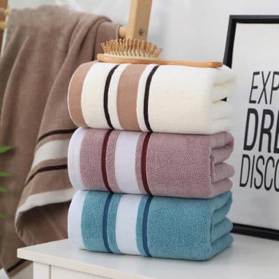 Soft, colorful towels neatly stacked at Monalisa Medical Store, ideal for luxury bathroom and skincare routines, offering comfort and elegance.