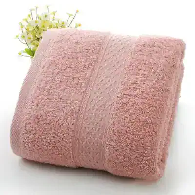 Luxury pink terry cloth bath towel with decorative border for spa and hotel use.