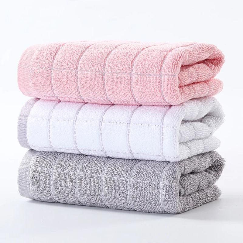 Soft pastel-colored towels stacked in pink, white, and gray at Monalisa Store, perfect for personal care, spa, or skincare routines, emphasizing comfort and quality.