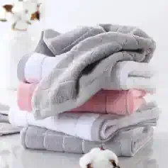 Luxury microfiber towels folded in neutral colors at Monalisa Store for premium skincare and spa use.