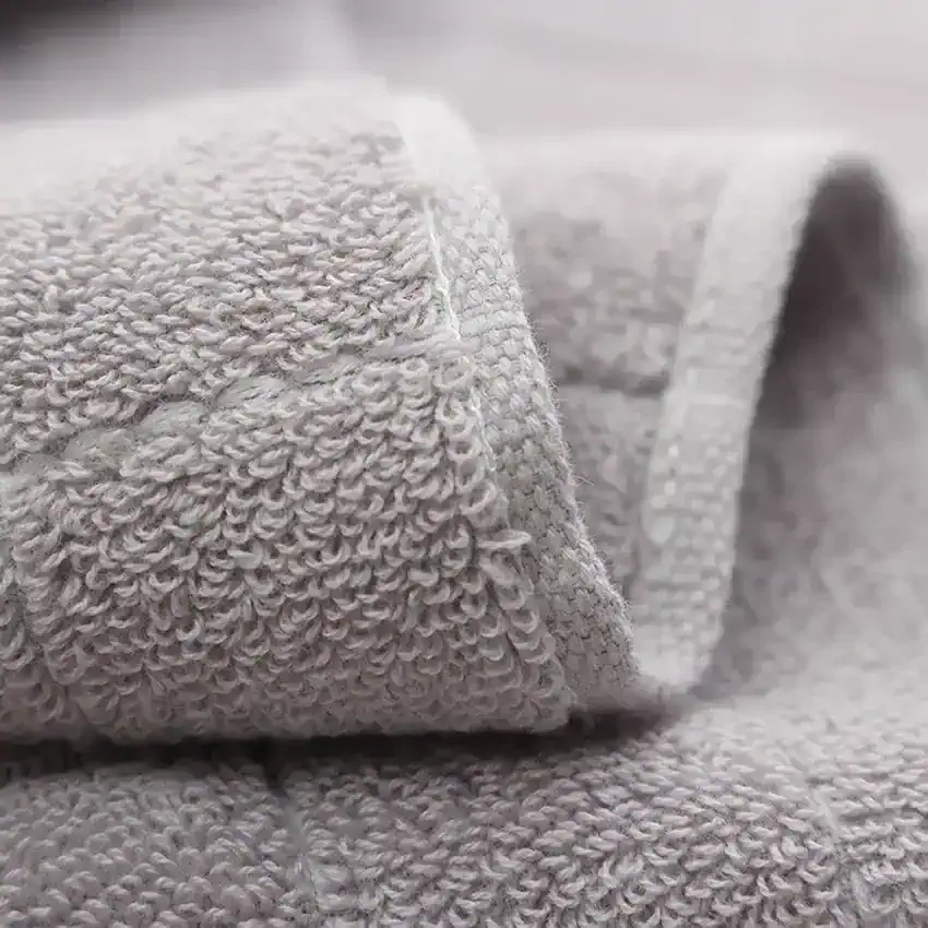 Luxury gray towel set with embroidered logo, monalisa store, high-quality hotel-style linens, plush bath towels, soft and absorbent, perfect for home or spa use, premium textile products for comfort and style.