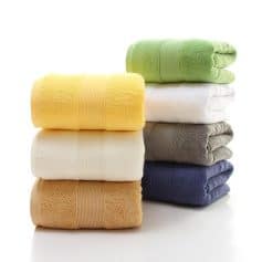 Colorful folded towels stack, showcasing plush, soft textures perfect for home or spa use, available at Monalisa Store.