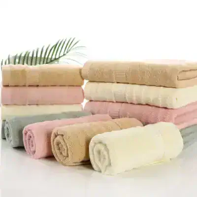 Luxurious cotton towels in pastel shades stacked neatly, ideal for a spa or hotel. Soft, absorbent, and plush for everyday comfort and luxury bath experiences. Perfect for home or commercial use.