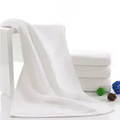Pure white bed sheet draped over a simple frame with folded sheets and colorful decorative balls on a white background.