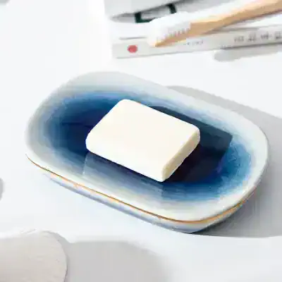 Moisturizing soap bar on blue and white ceramic dish, skincare product, Monalisa Store skincare essentials, hygiene and beauty care, soap bar for clean, healthy skin, skincare routine, natural cleansing product.